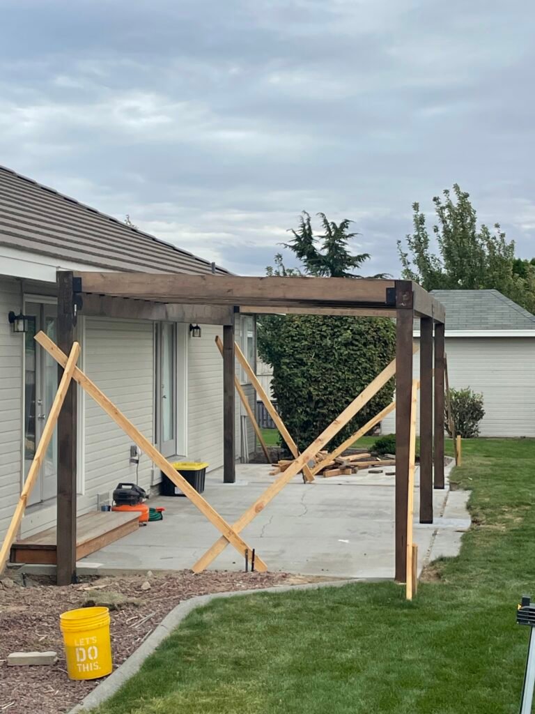 Custom wood patio cover under construction by Barean Hilu LLC, creating a durable outdoor living space for a homeowner in the Tri-Cities region of Eastern Washington.